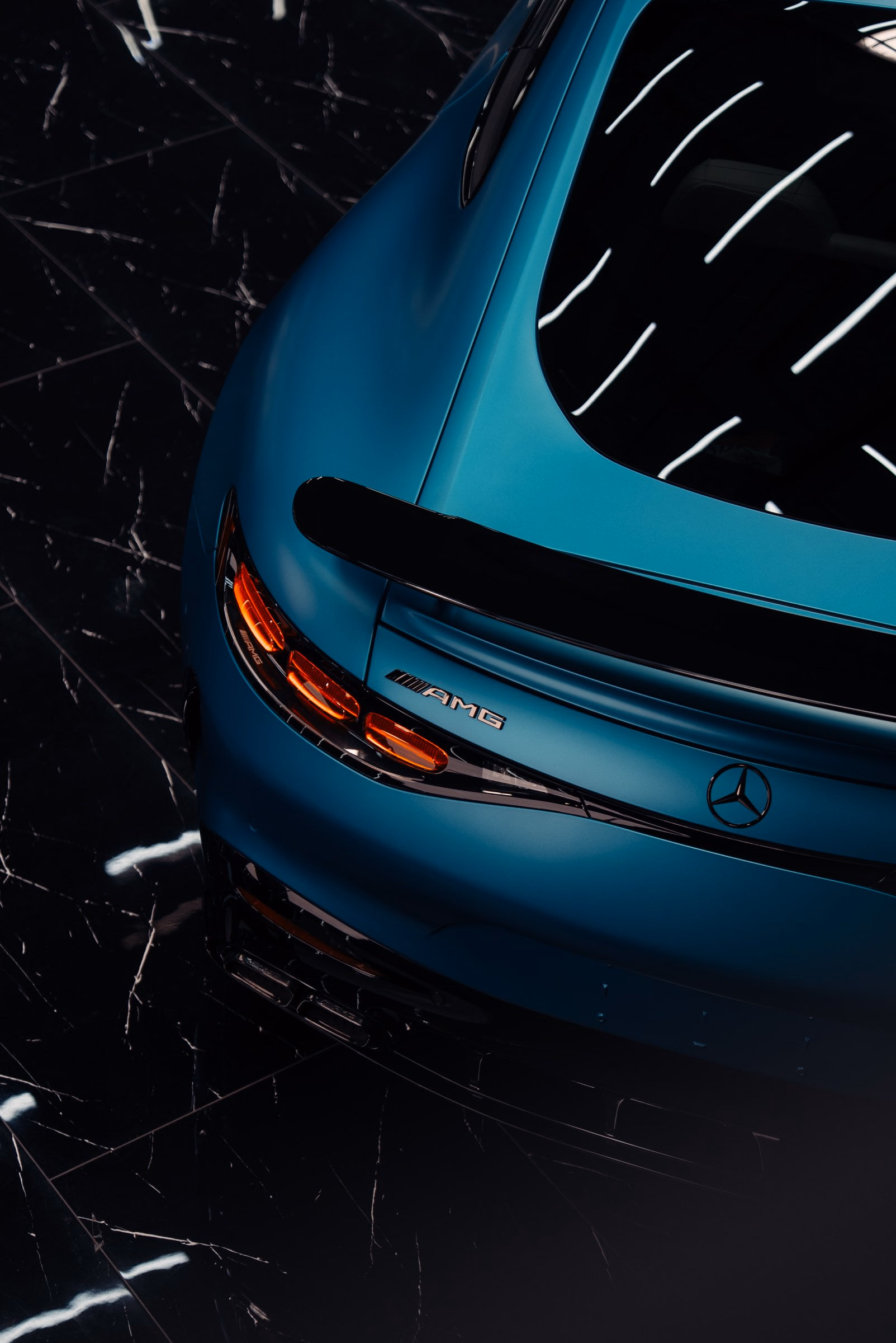 The rear of a satin teal Mercedes-AMG GT photographed from above after paint correction