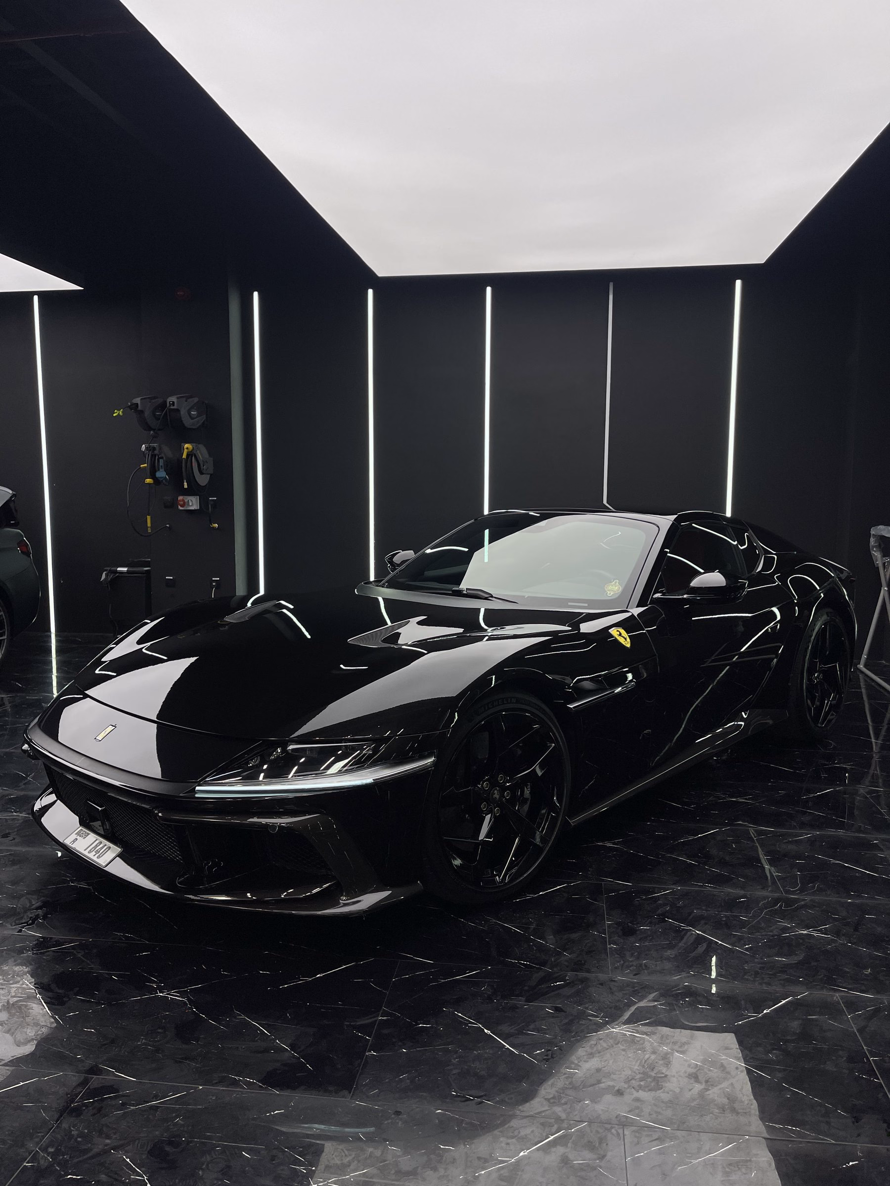 Black Ferrari 812 photographed from the front three-quarter after full body paint protection film and paint correction