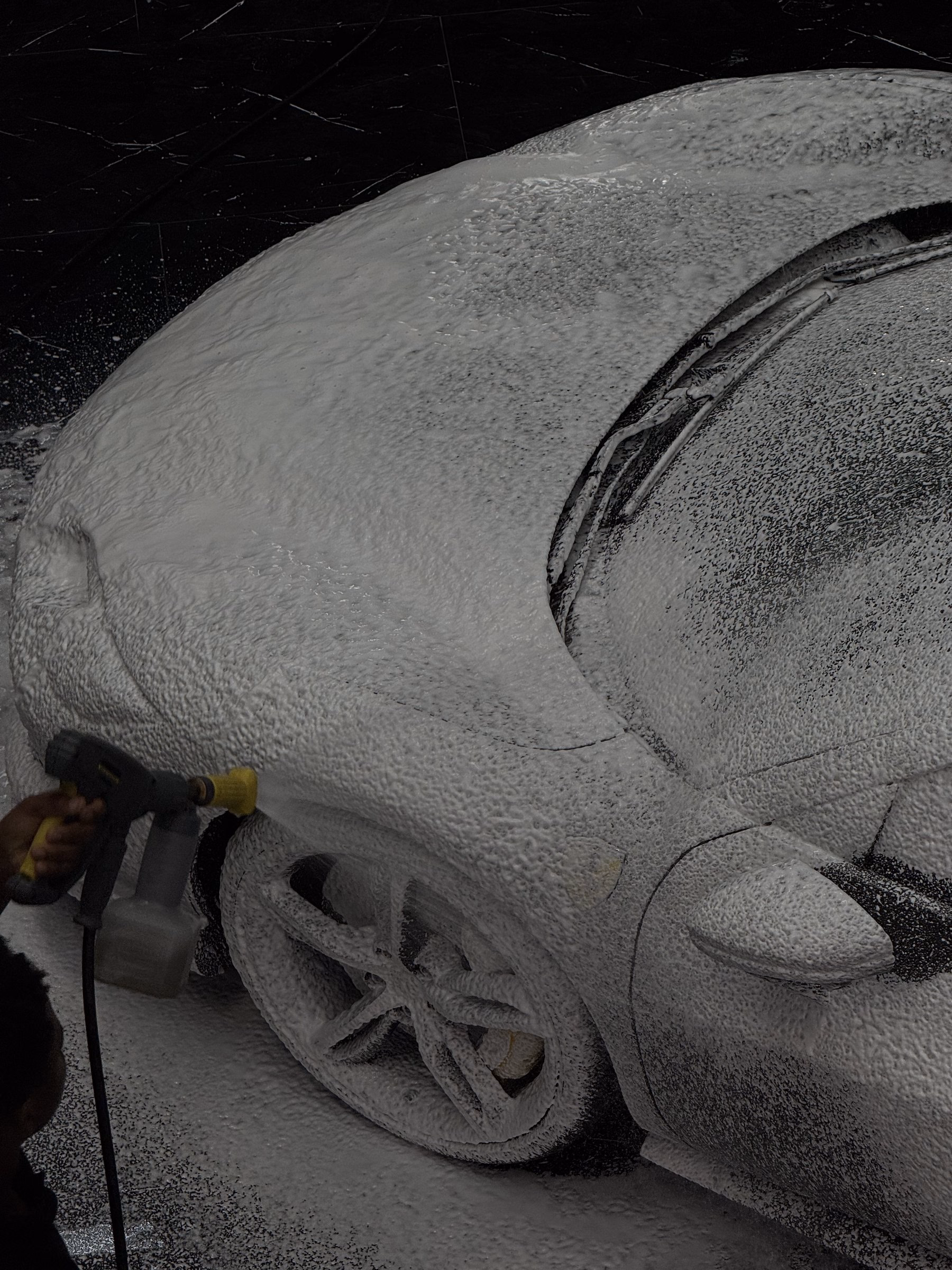 A car covered in cleaning foam during a premium hand wash at the MAER studio