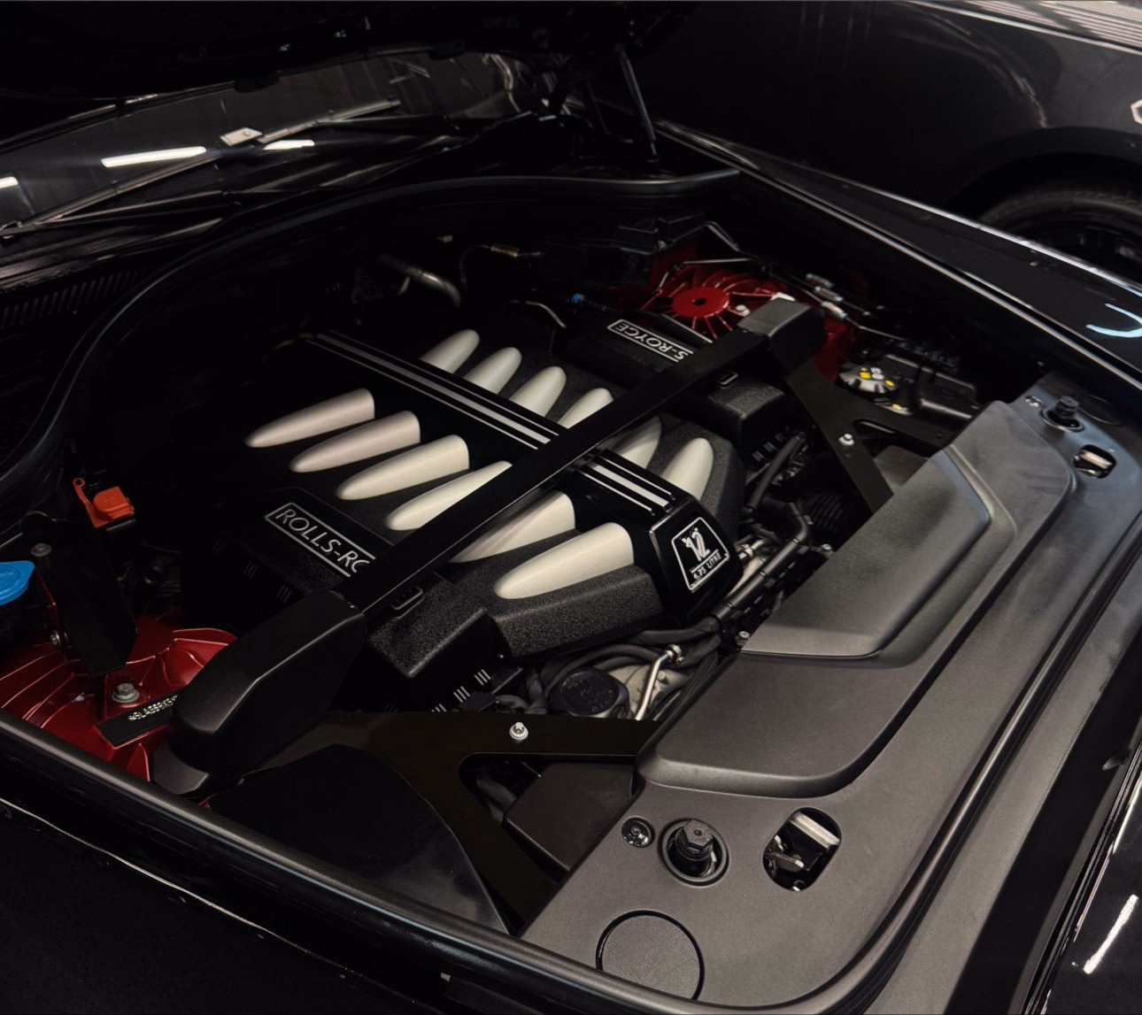The same Rolls-Royce V12 engine bay after a full deep clean, every surface clear of dust